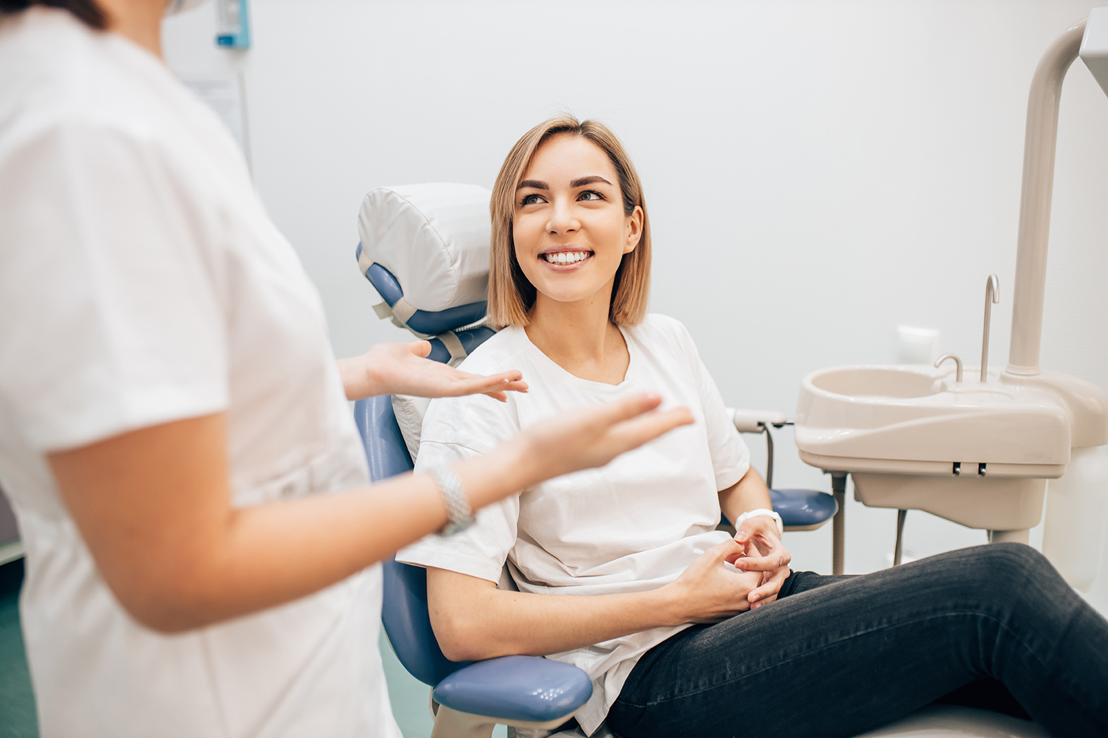 woman talking to dental hygienist at All Smiles Family & Cosmetic Dentistry