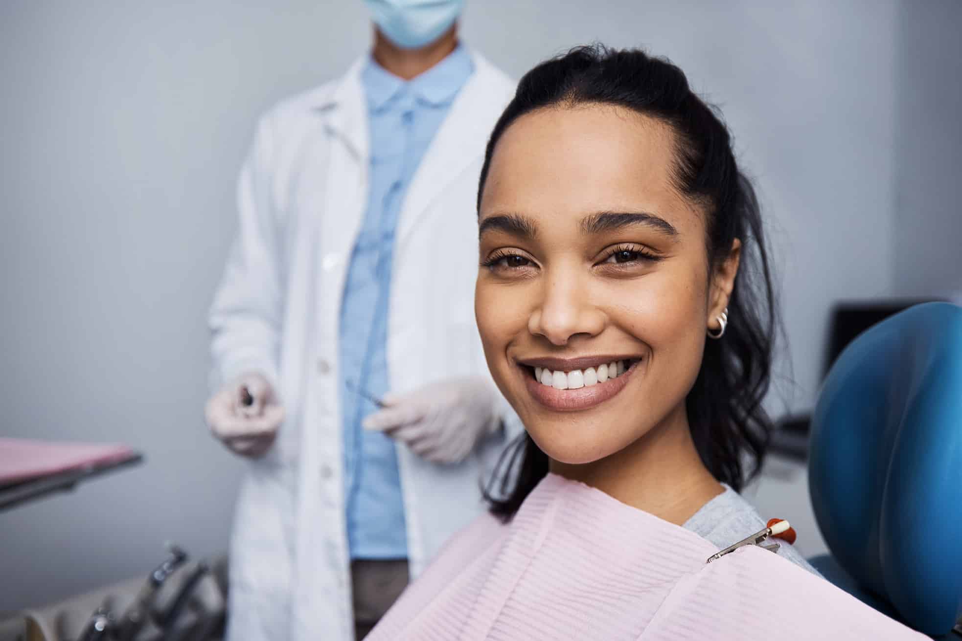 woman smiling during cosmetic dental appointment at All Smiles Family & Cosmetic Dentistry