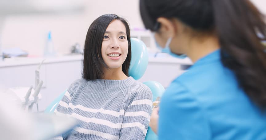 dental patient talking with dr miles during dental cleaning appointment in cumming ga