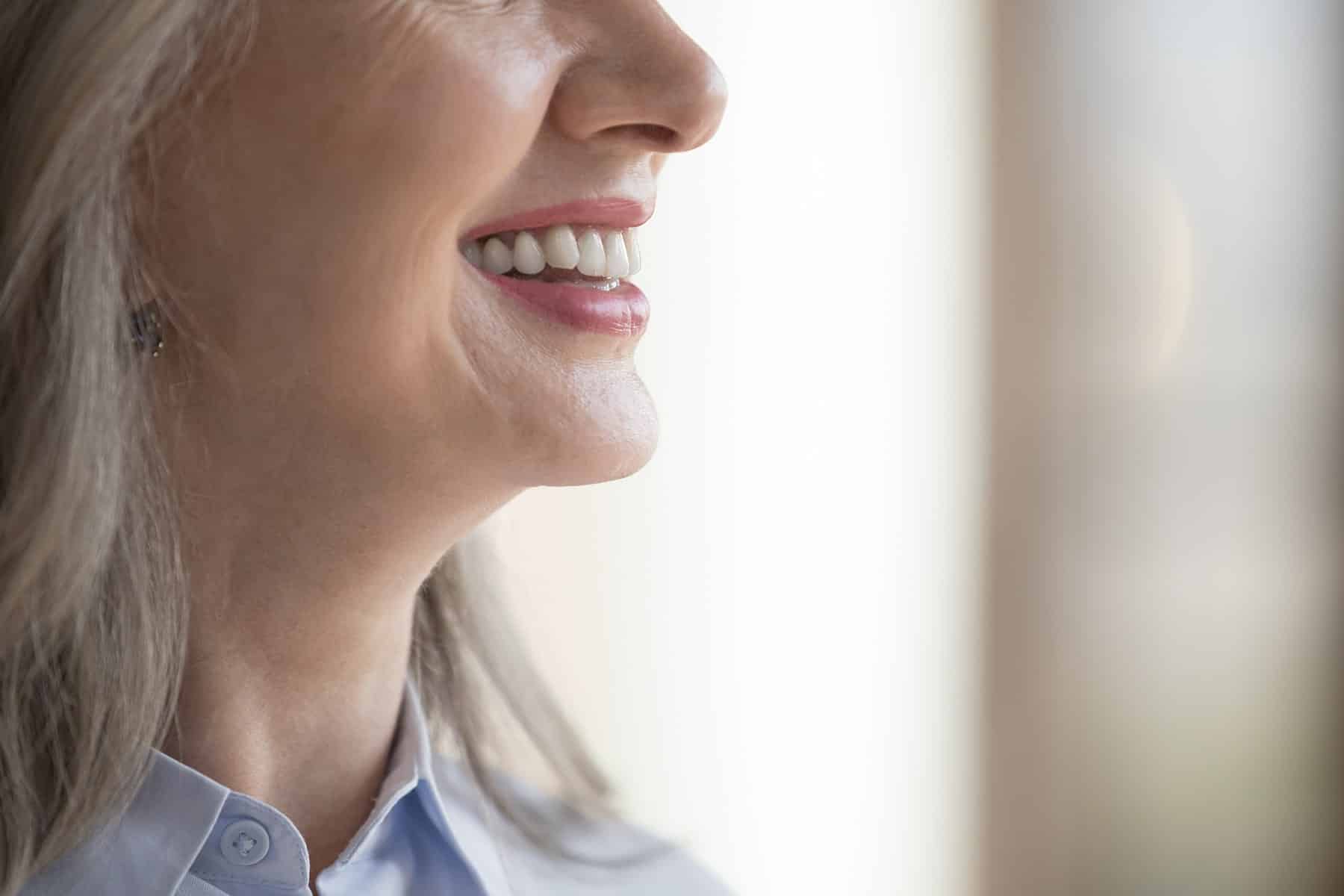 Woman smiling after dental crown treatment in Cumming, GA