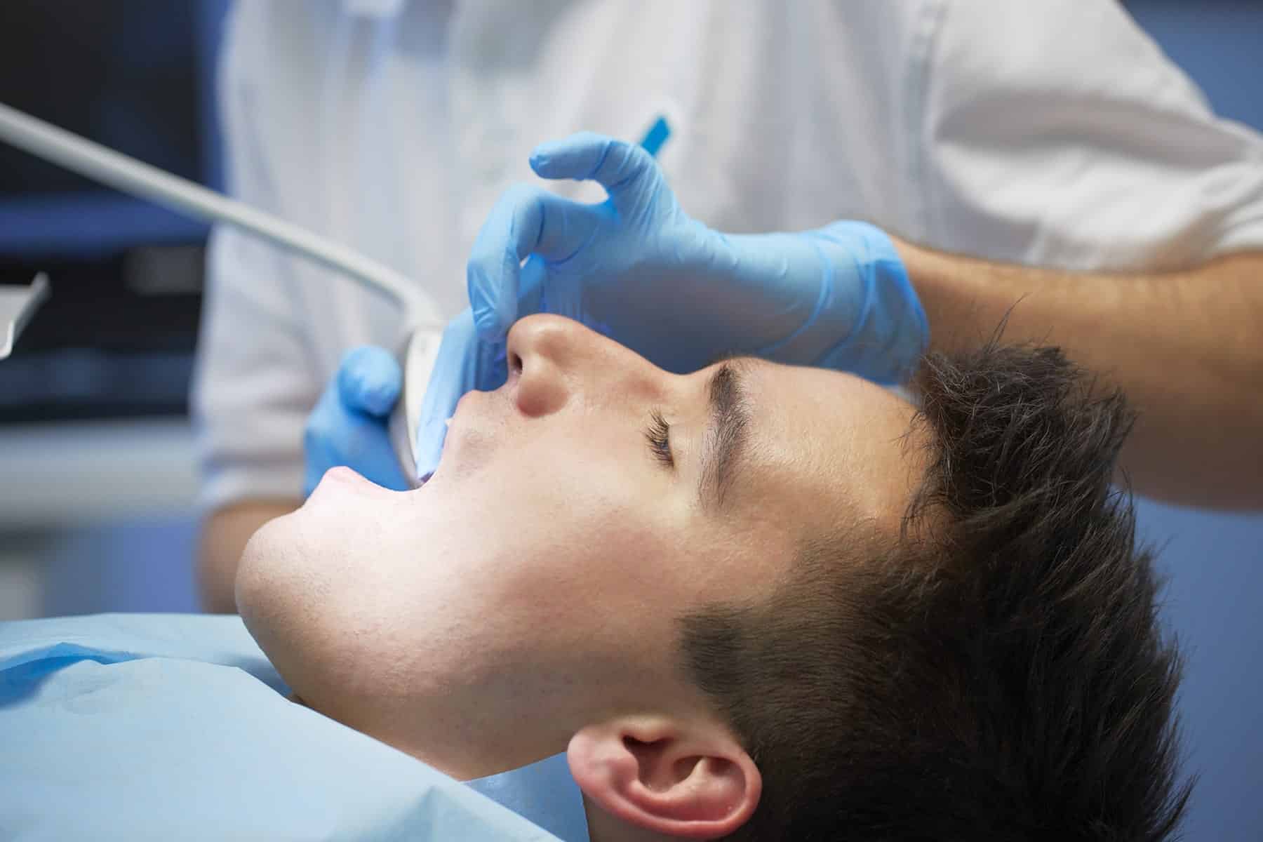 Man getting a dental exam in Cumming, GA